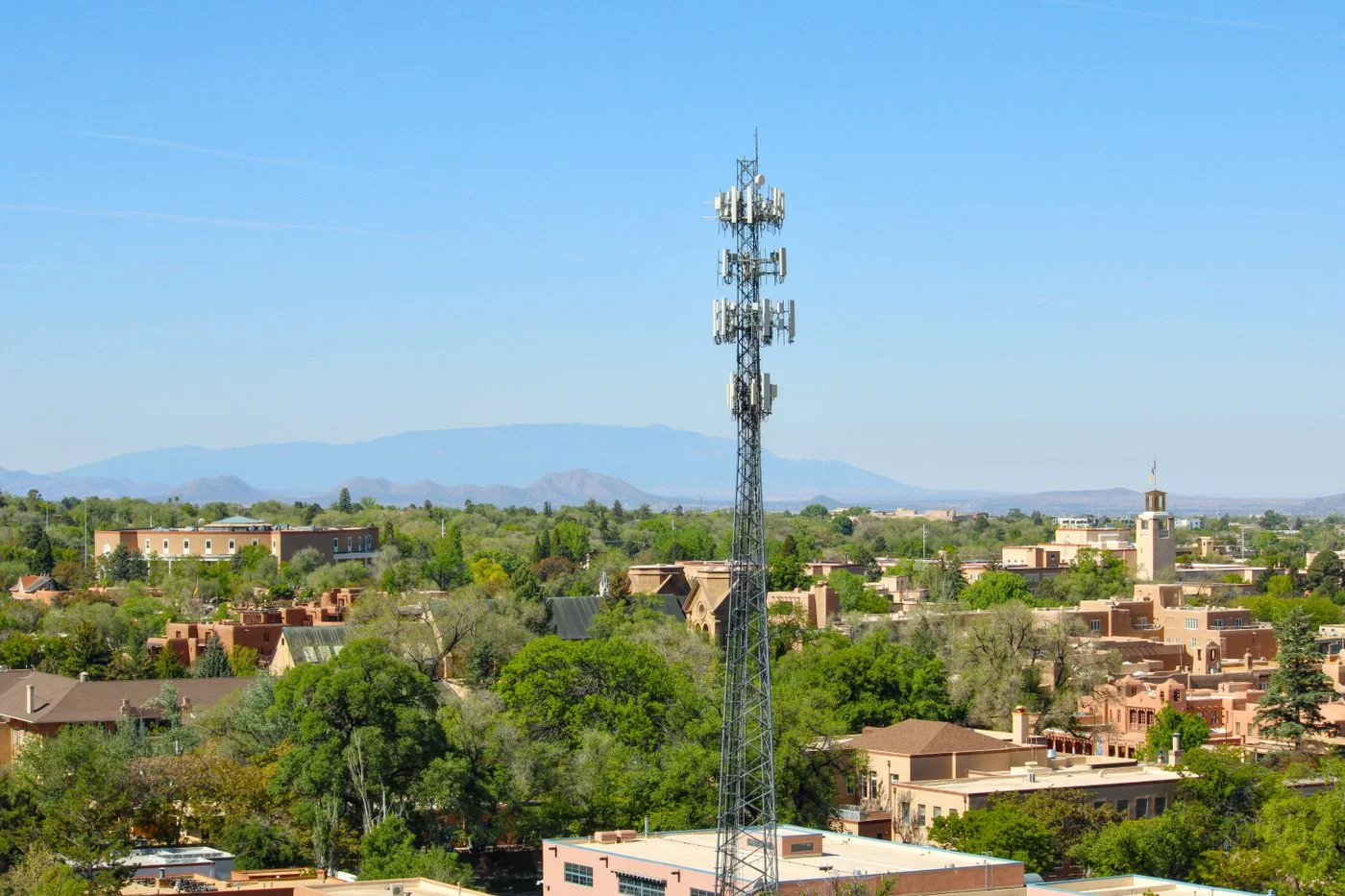 Adobe buildings and a communications tower in Santa Fe