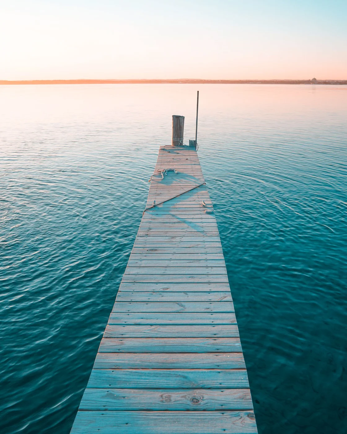 A pier extending into calm water in Traverse City Michigan